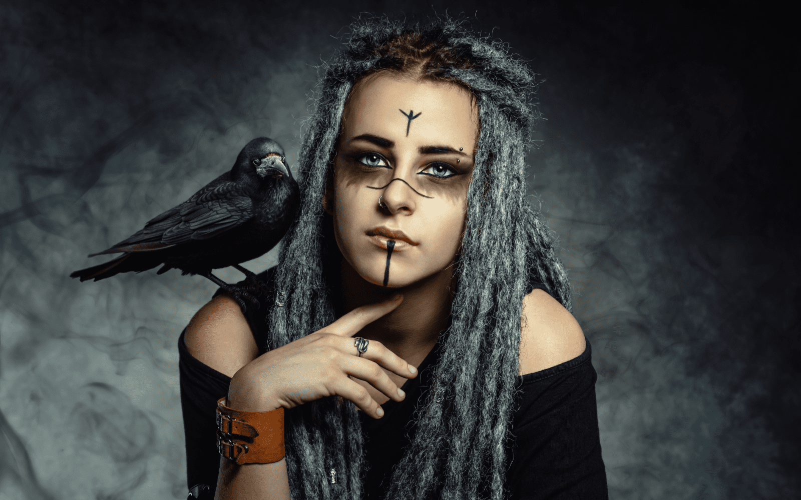 Femme Viking portant de belles dreadlocks et un corbeau sur l'epaule